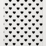 White fleece blanket with black heart pattern.