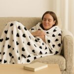 White fleece blanket with black heart pattern. - Image 2